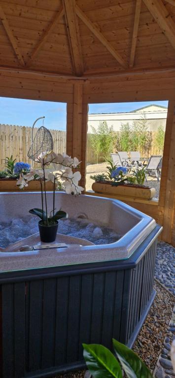 a jacuzzi tub in a patio with a wooden roof at Yellow Stone Farm Lodge and Spa in Clonbrown