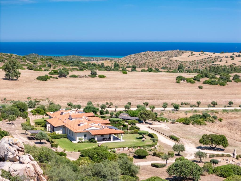 an aerial view of a house with the ocean in the background at Sole d'Estate Agriresidence in Costa Rei