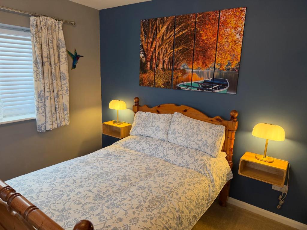 a bedroom with a bed and two lamps on tables at The Escape in Wirksworth