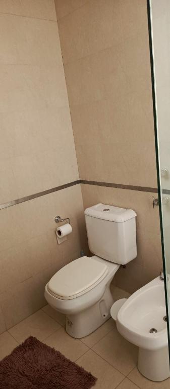 a bathroom with a toilet and a sink at Departamento duplex in Concordia