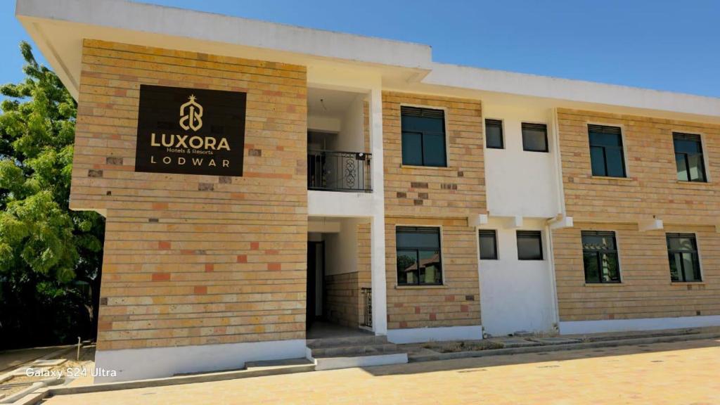 a building with a sign on the side of it at Luxora Hotel Lodwar in Lodwar