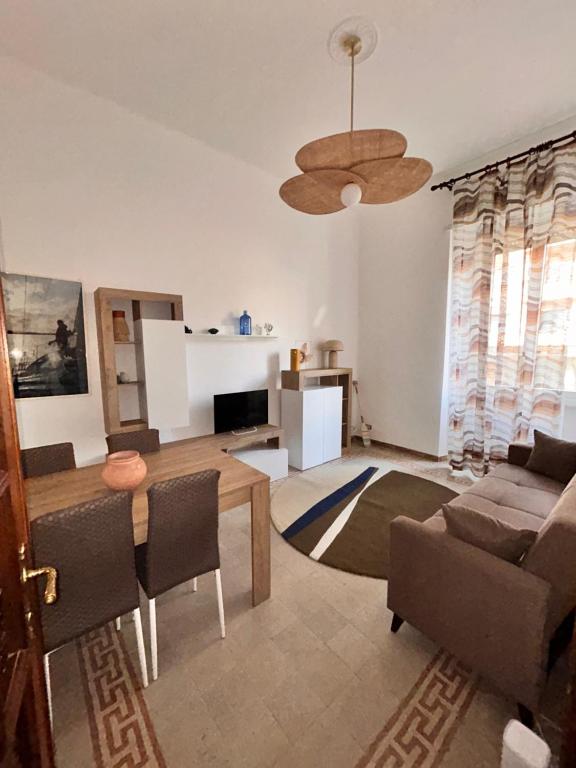 a living room with a couch and a table at Odissea Apartment City Center & 2 Min to Beach in Nettuno
