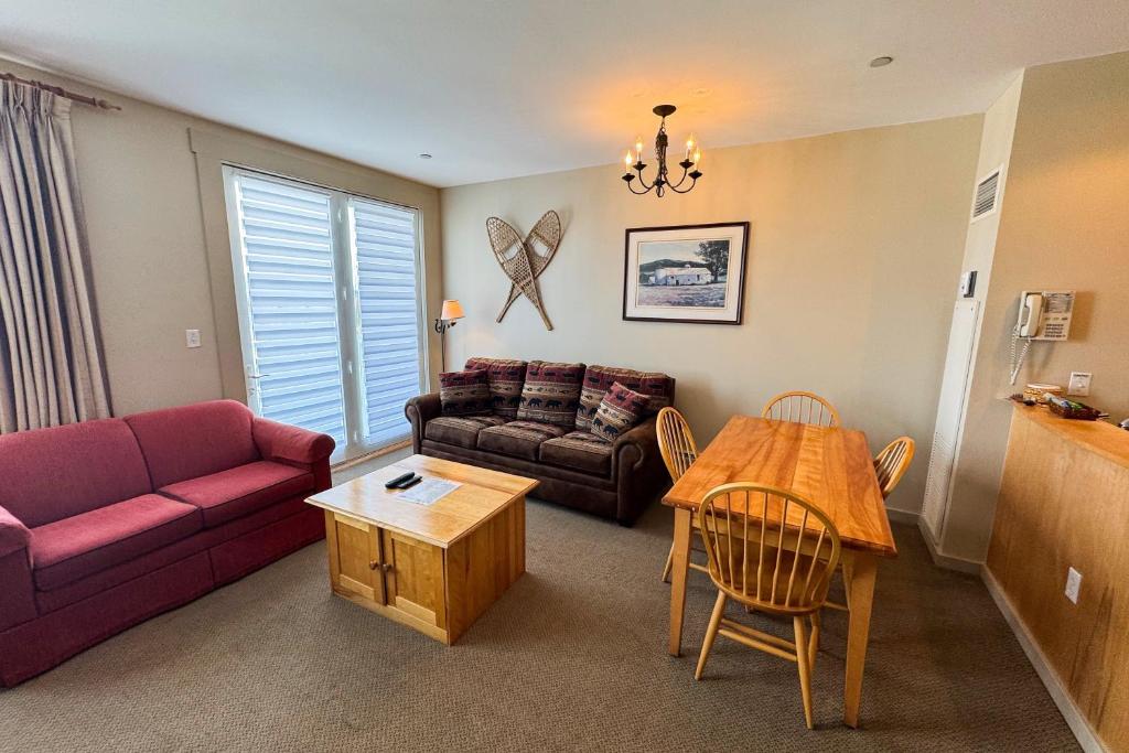 a living room with a couch and a table at Long Trail House 459 in Stratton