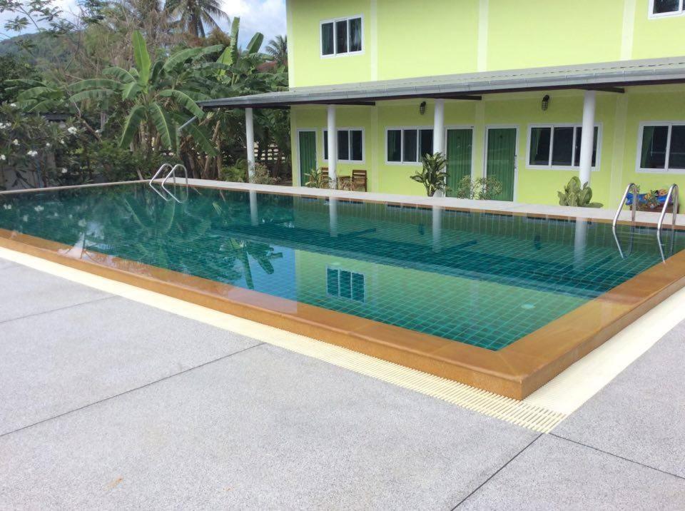 a swimming pool in front of a house at Subsavet Village in Ban Tai