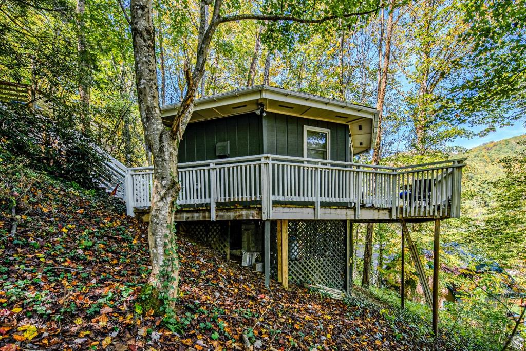 a tree house with a deck in the woods at The Treehouse at Banner Elk in Banner Elk