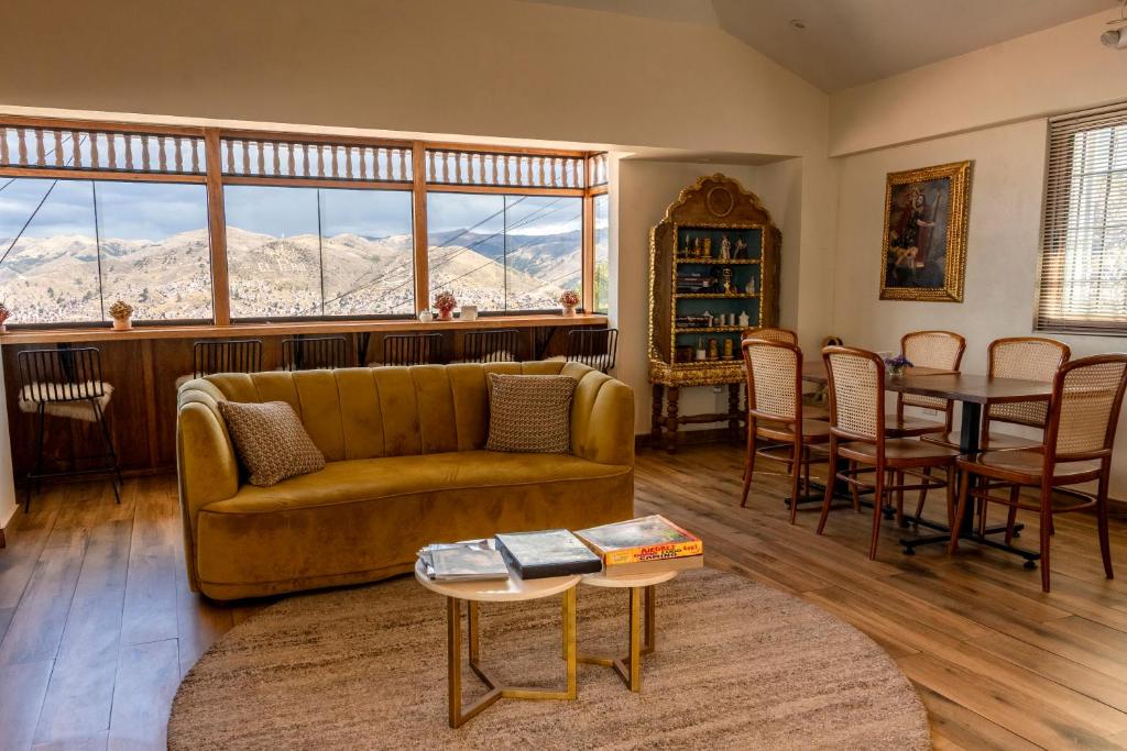 a living room with a couch and a table at Inkantari Boutique Hotel in Cusco