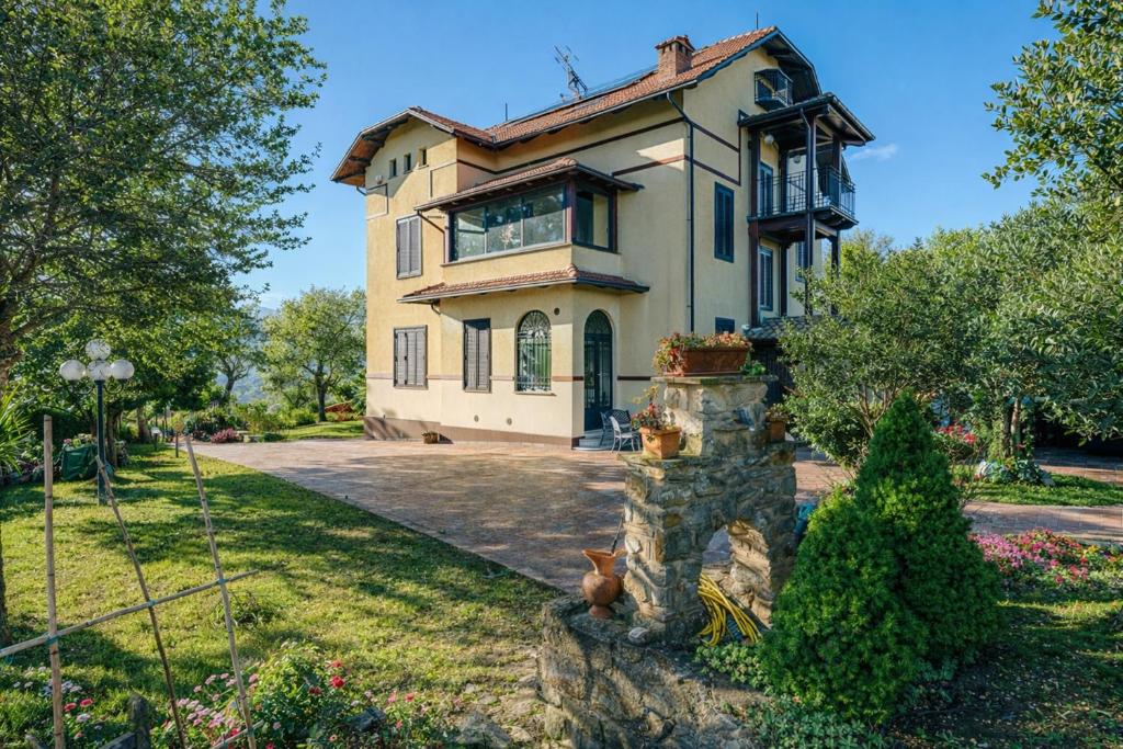 a house with a dog sitting in front of it at Villa Fefa by MMega in Tolentino