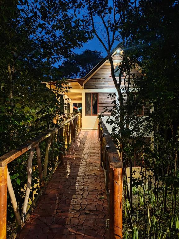 a house with a brick walkway in front of it at Eco Aldea kinich Ahau Calakmul in Xpujil