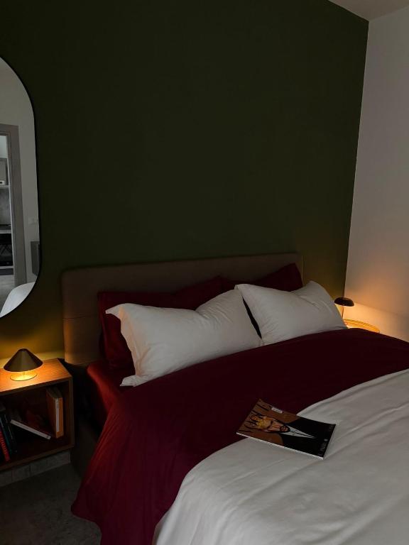 a bedroom with a bed with a book on it at R Apartment - Venaria in Venaria Reale