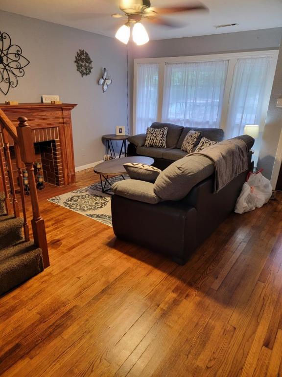 a living room with a couch and a fireplace at 5 minutes from Garrison Ave in Fort Smith