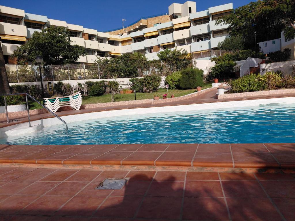 a swimming pool in front of a building at Sun and ocean in San Bartolomé