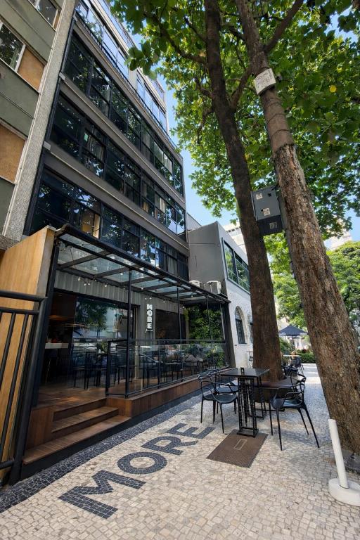 a building with tables and chairs in front of it at More Ipanema Hostel in Rio de Janeiro