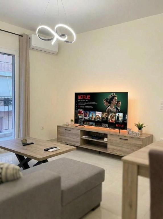 a living room with a flat screen tv on the wall at Ionian Port Suite in Ágios Rókkos