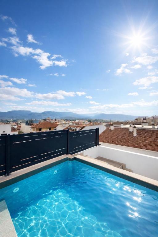 a swimming pool on the roof of a building at Avanel Private Pool Penthouse in Ronda