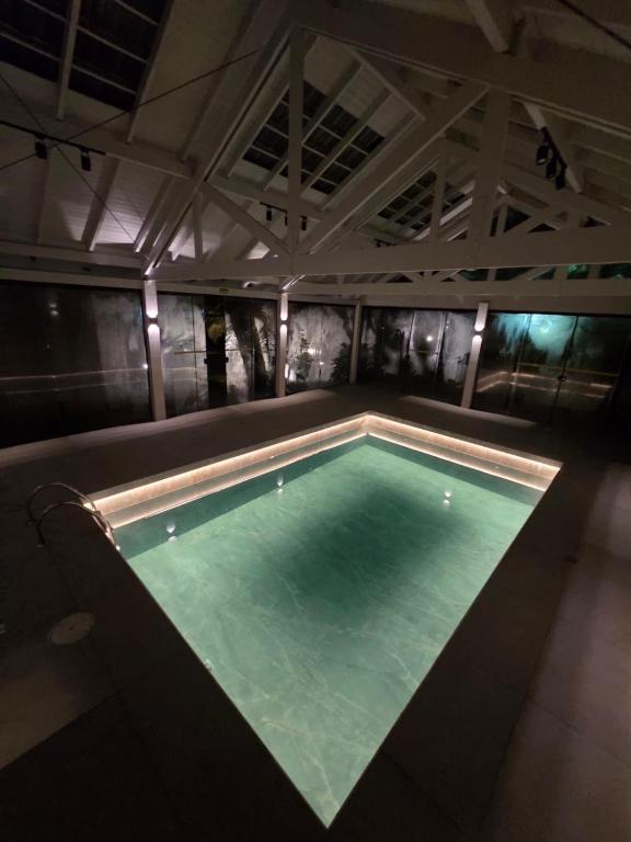 a large swimming pool in a building with at Lê Château Hotel de Gramado, seu refúgio no centro da cidade in Gramado