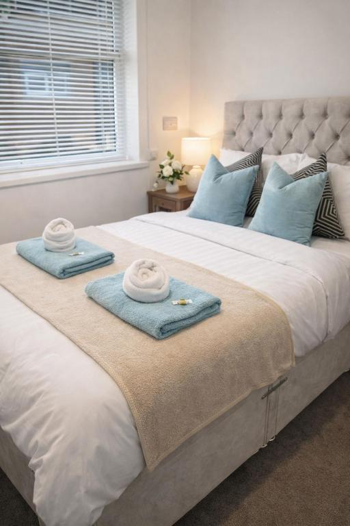 two towels are sitting on top of a bed at Large 4 bedroom house for Contractors, Large groups or Retreat sleeps 8 people in Durham - NO Smoking Indoor House in Edmondsley