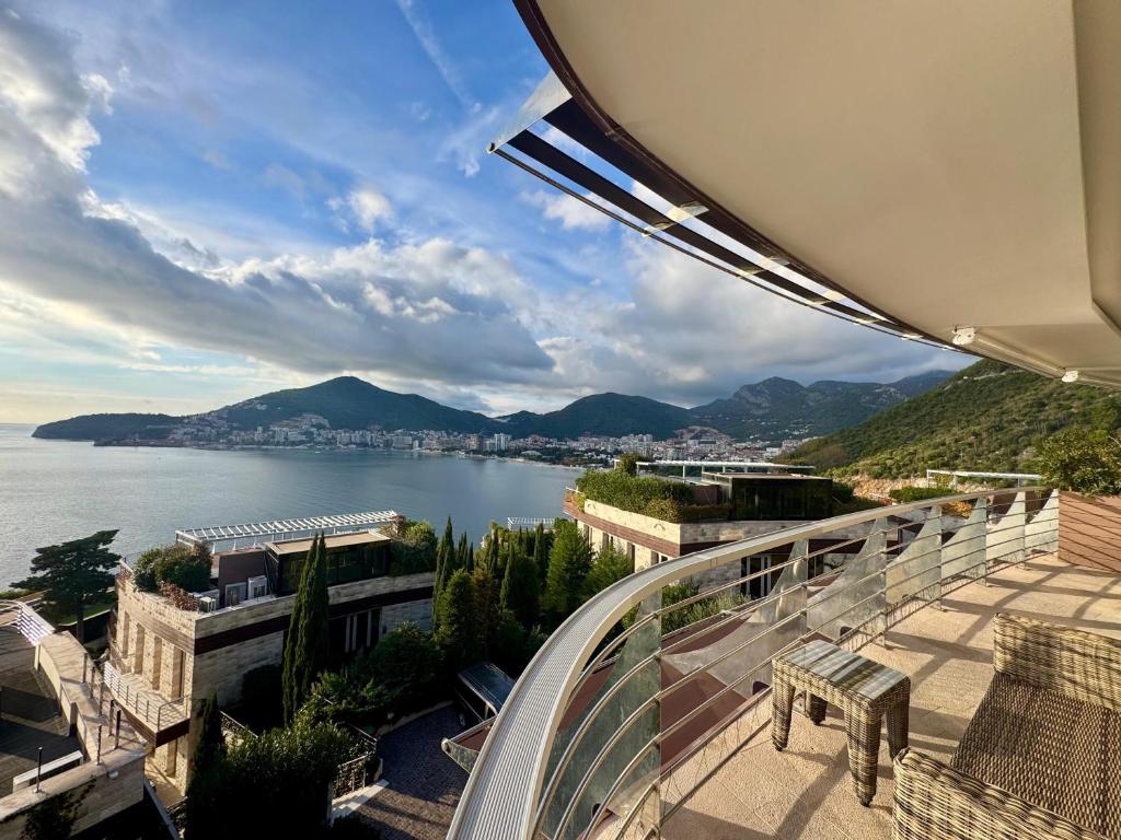 a balcony with a view of a body of water at Casa La Perla in Budva