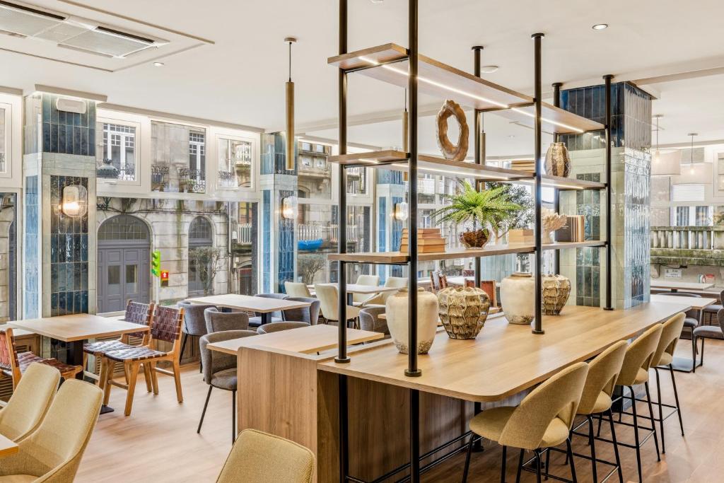a dining room with tables and chairs at B&B HOTEL Vigo in Vigo