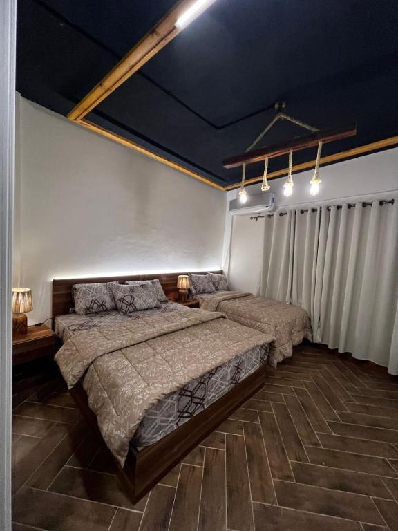 a bedroom with two beds and a blue ceiling at 44 Inn in Dahab
