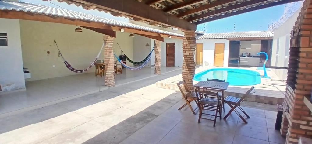 a patio with a table and chairs and a swimming pool at Casa Parnaíba in Parnaíba