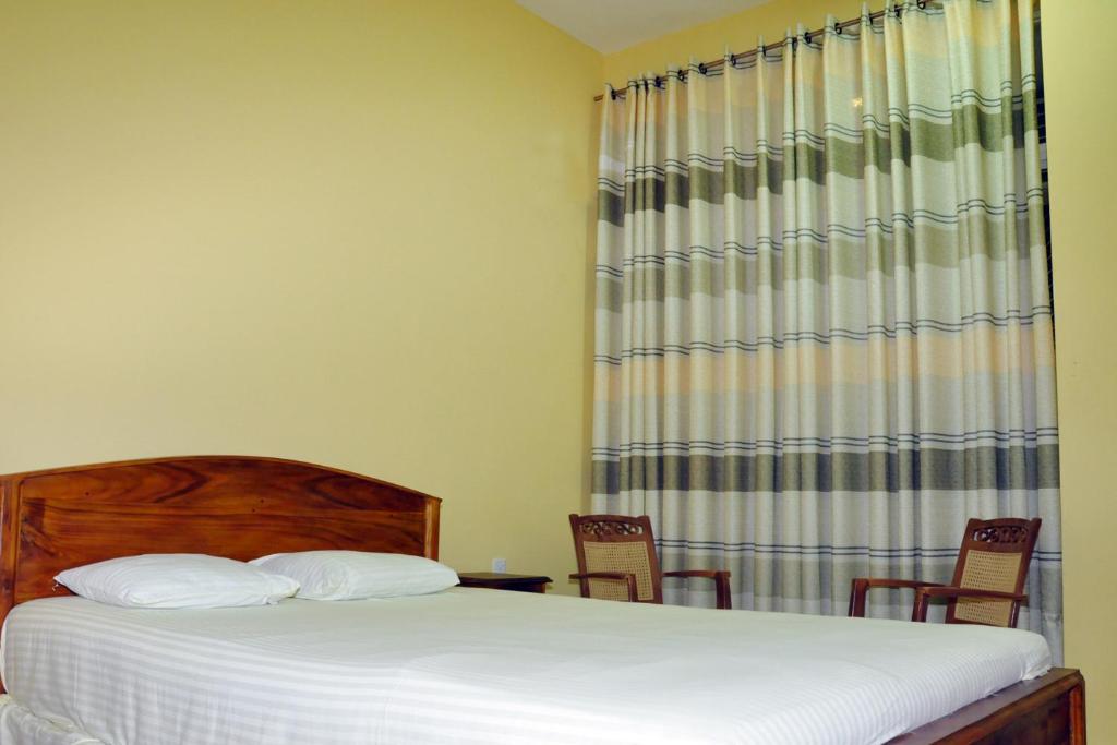 Postel nebo postele na pokoji v ubytování Hotel Pearl Gate