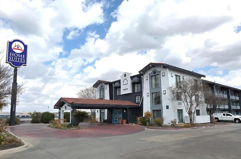 a hotel building with a sign in front of it at Home Suites Culebra in San Antonio