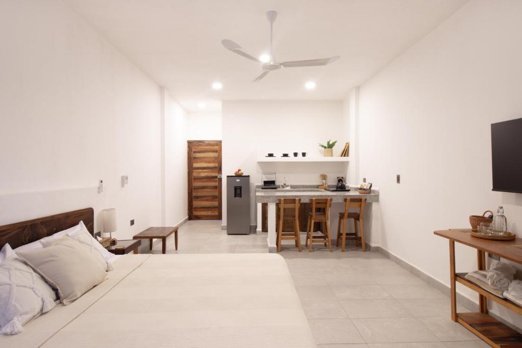 a living room with a bed and a kitchen at Casa Pola in Malucano