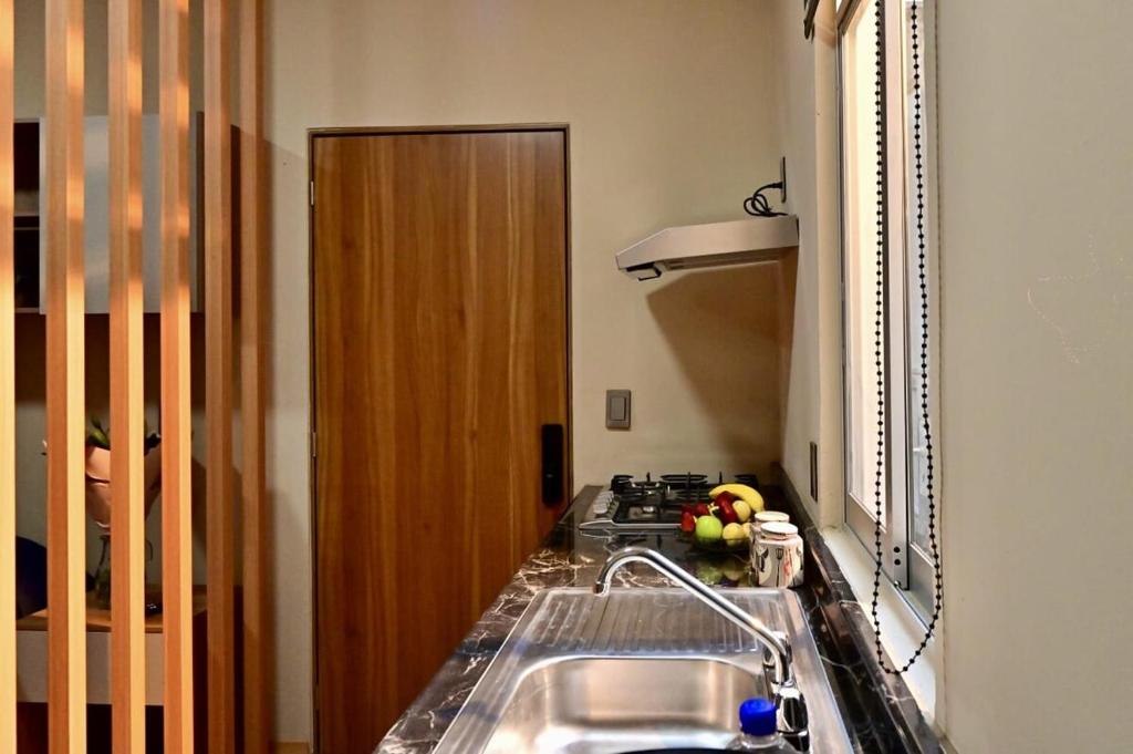 a kitchen with a sink and a stove at Loft centrico en Morelia in Morelia