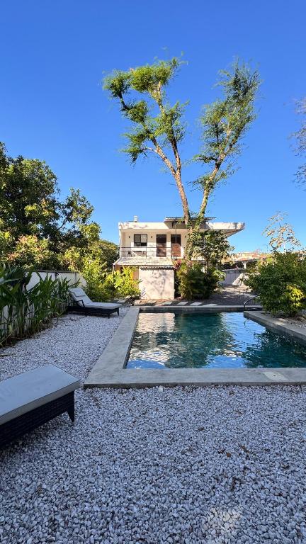 a house with a swimming pool in the middle of a yard at GZ Suites in Coco