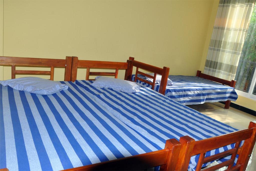 Postel nebo postele na pokoji v ubytování Hotel Pearl Gate