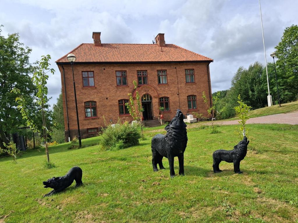 three statues of horses in front of a house at Private floor in Molkom