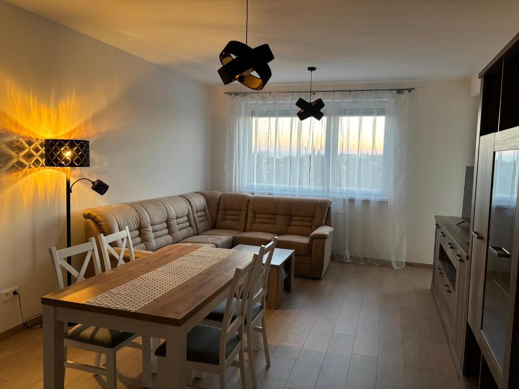 a living room with a couch and a table at Lima Apartment in Bernolákovo