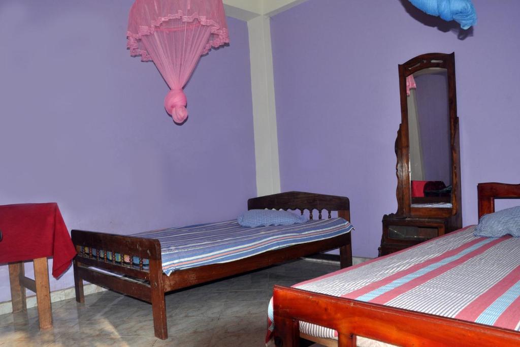 Postel nebo postele na pokoji v ubytování Hotel Pearl Gate