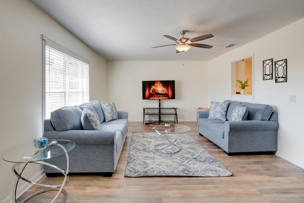 a living room with two couches and a ceiling fan at Steps from Crystal River: Crystal River Getaway! in Crystal River
