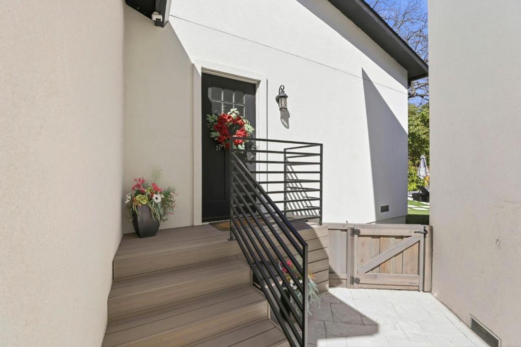 a stairway leading to a white house with flowers on it at Angie Oasis Yard, Loft & Stocked Kitchen in San Ramon