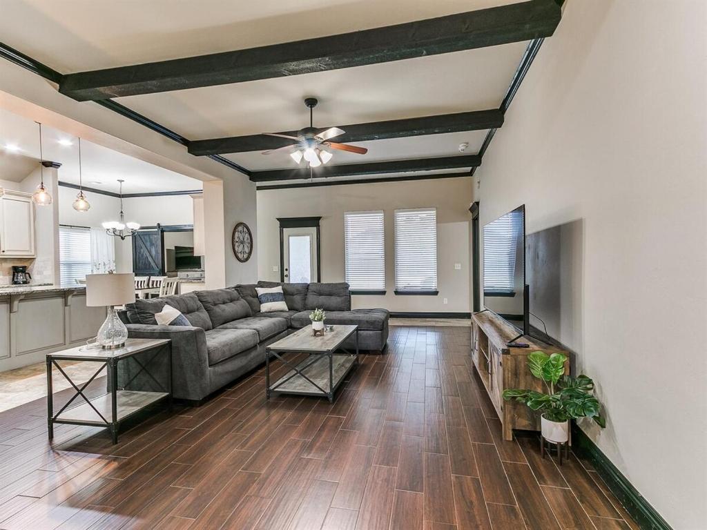 a living room with a couch and a tv at Spacious Deer Creek Home with Study and Yard in Edmond