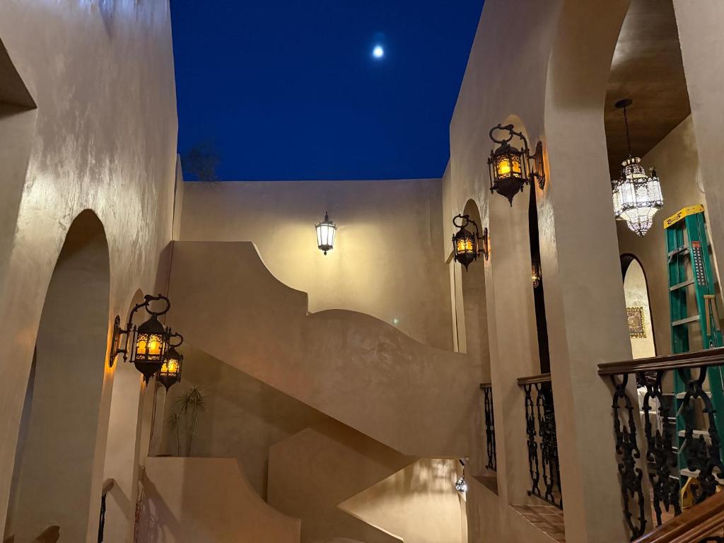 a staircase in a building with lights and a blue ceiling at Riad Xula Boutique Hotel in Puerto Peñasco