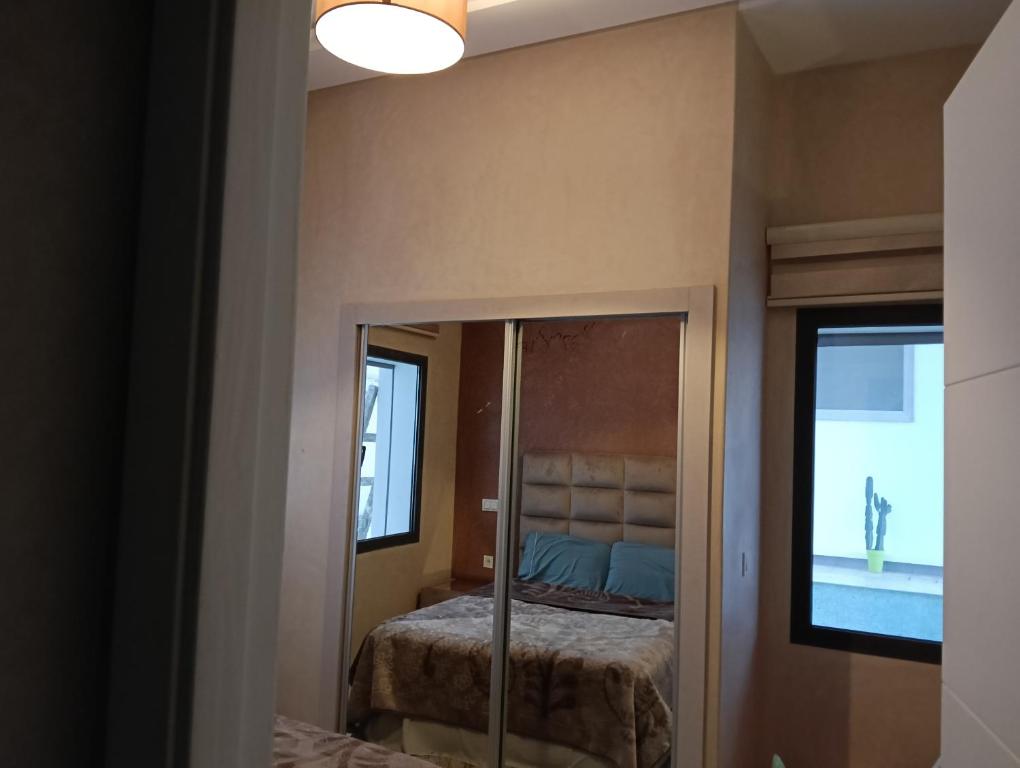 a bedroom with a mirror and a bed in it at Apartment in Tanger in Tangier