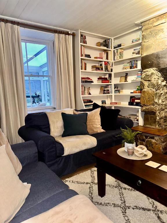 a living room with a couch and a table at Snowdon Retreat in Llanberis