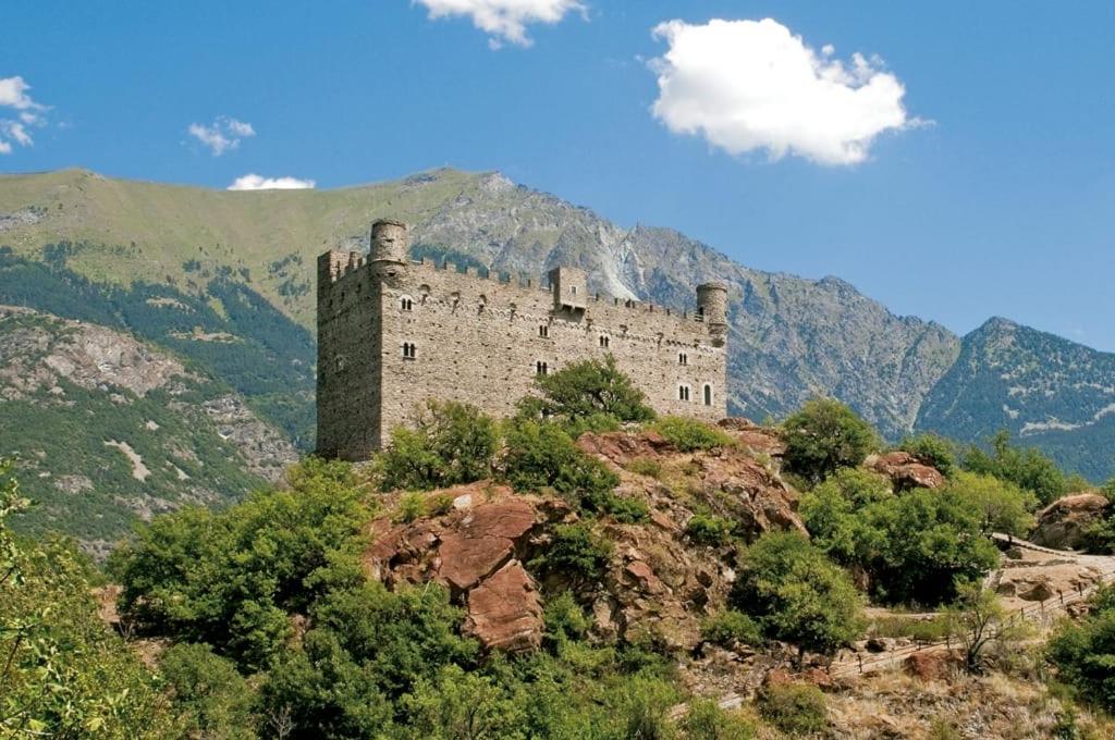 a castle sitting on top of a mountain at Pres du Chateau in Châtillon