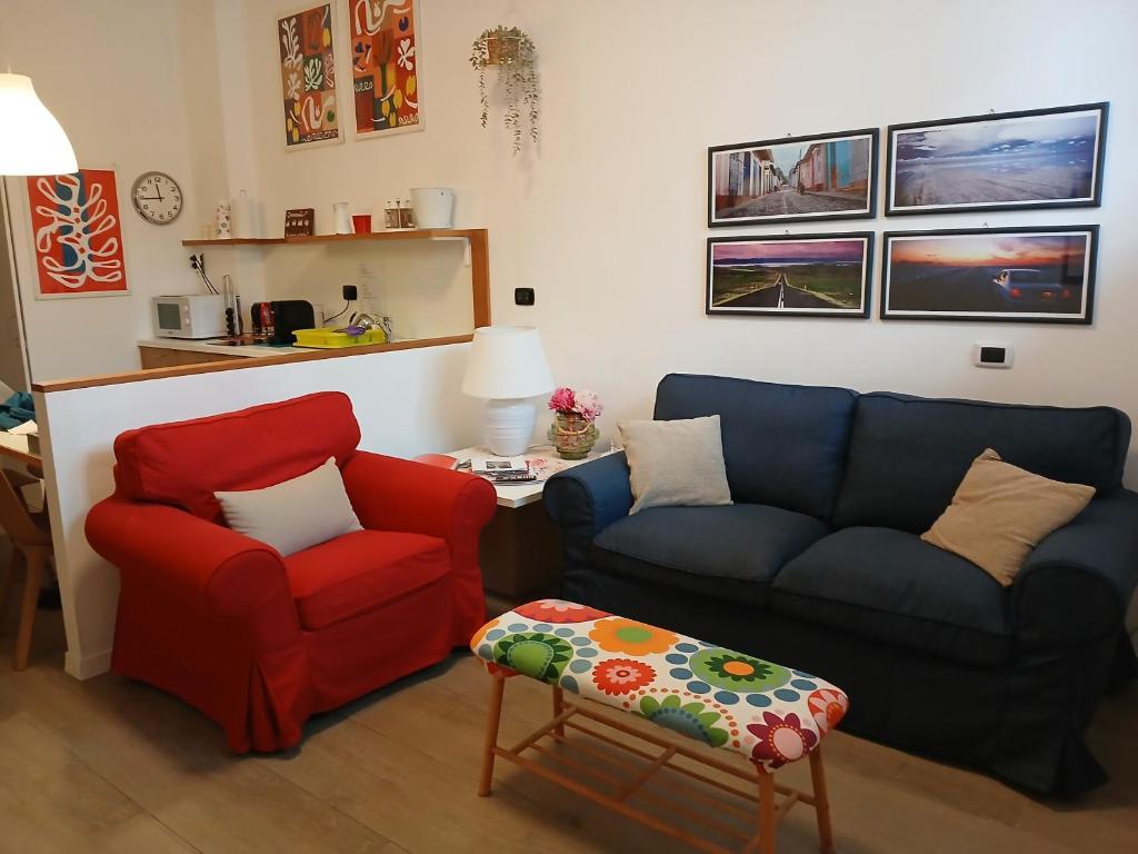 a living room with a couch and a chair at La dimora di Amélie Parcheggio gratuito in San Lazzaro di Savena