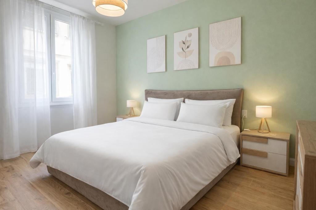 a bedroom with a large white bed and two lamps at Casa Camelia in Scarperia