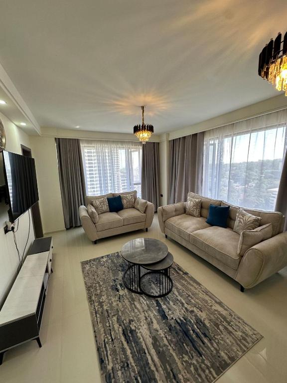 a living room with two couches and a table at The Nairobi Experience in Nairobi