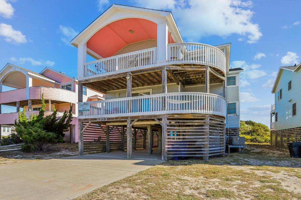 a house with a spiral staircase in front of it at 5437 - WeekAway in Nags Head