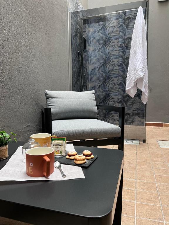 a table with a cup of coffee and donuts on it at NoveQuattro Apartment in Cagliari