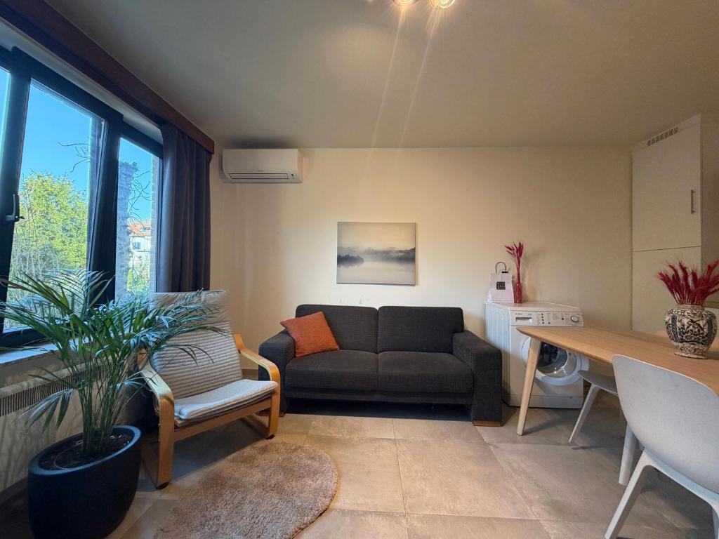 a living room with a couch and a table at Studio in Leuven in Leuven