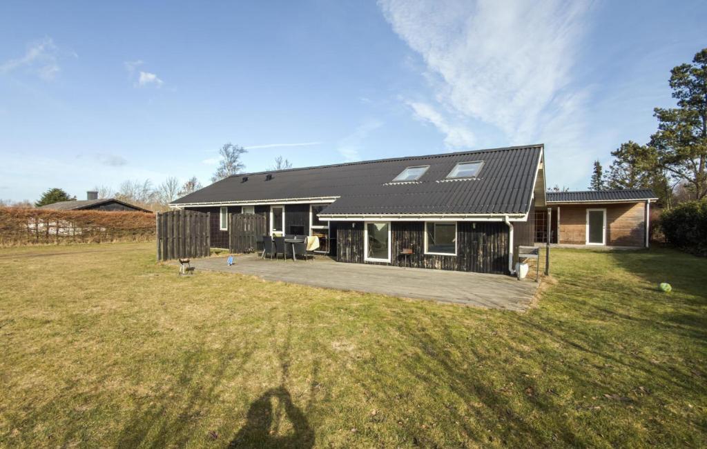 a house with a large yard in front of it at 4 Bedroom Amazing Home In Ørsted in Ørsted
