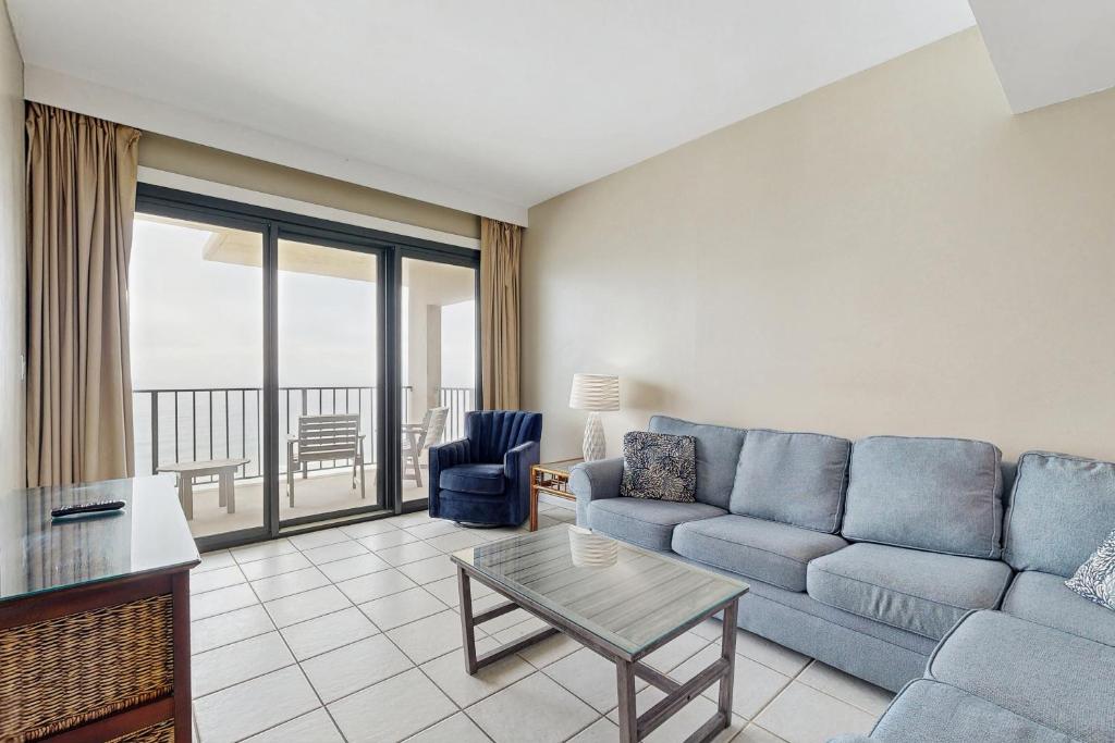 a living room with a couch and a table at Phoenix I 1142 in Orange Beach