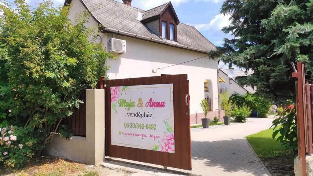 a white building with a sign in front of it at Maja Anna Vendégház in Bogács