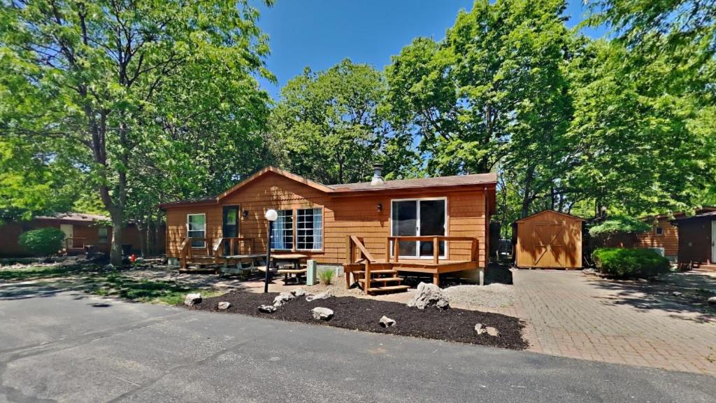 a log cabin with some birds in front of it at Put-in-Bay Island Club #71 in Put-in-Bay